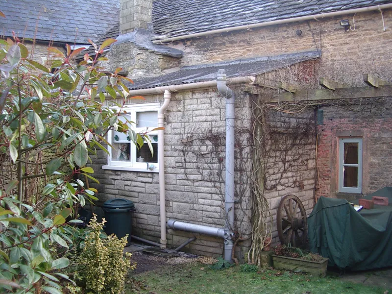 The Italian Courtyard Garden — Before An overgrown and unkempt garden in a small space behind an old cottage