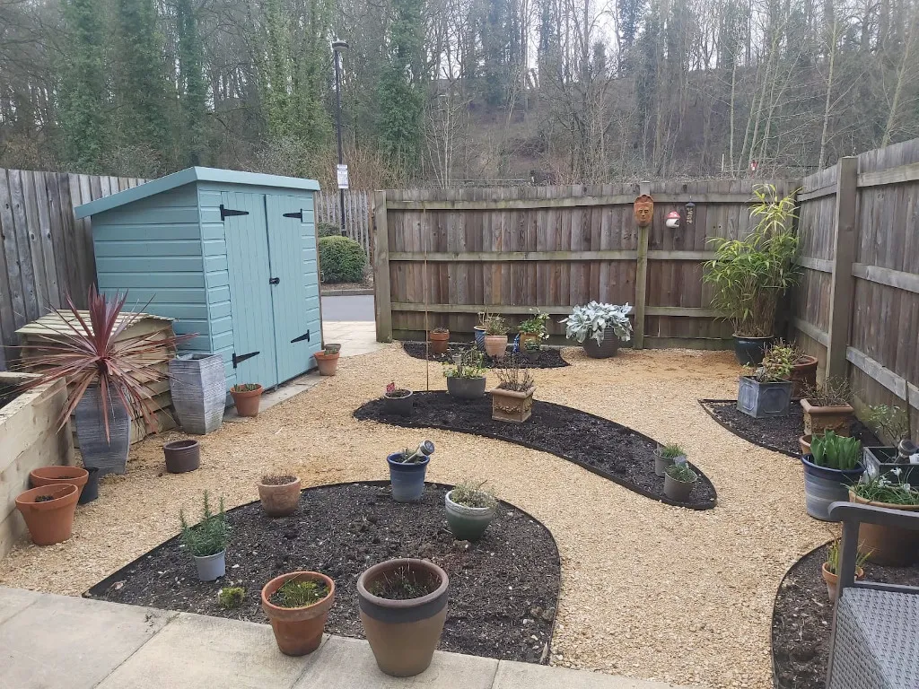 The Small Budget Garden — During The same space but with curved beds and gravel paths between them