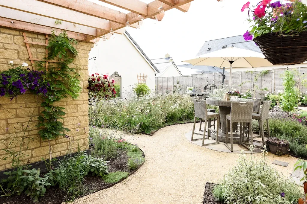After. Photo by Victoria Tapper The finished garden with a table and chairs on gravel paths winding through shrubs and wildflowers. Photo by Victoria Tapper