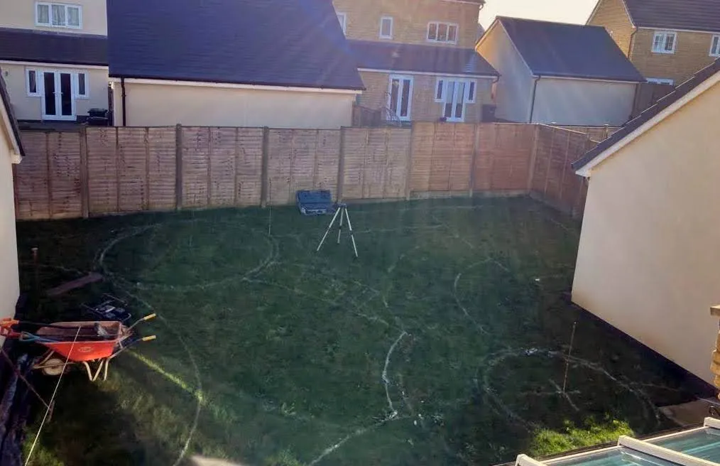 On the site of the garden before work starts, the lines of the same drawing are marked out on the grass.